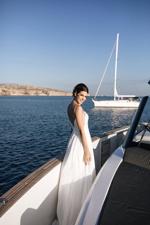 breathtaking-styled-shoot-board-magnificent-view-caldera-santorini-endless-blue-sea_13