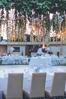 Στολισμός γαμήλιου τραπεζιού με κρεμαστές λευκές ορτανσίες και πρασινάδα Στολισμός γαμήλιου τραπεζιού με κρεμαστές λευκές ορτανσίες και πρασινάδα