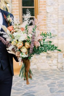 Νυφικό μπουκέτο από pampas grass, τριαντάφυλλα, γαρύφαλλα και άλλα ιδαίτερα λουλούδια σε γήινες αποχρώσεις