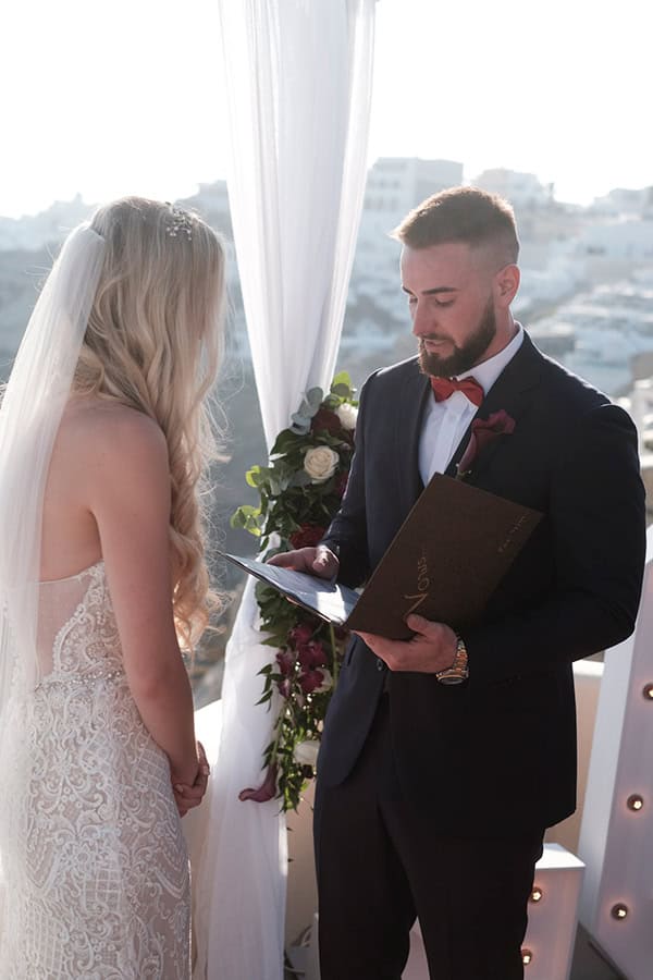 intimate-wedding-santorini-island-burgundy-hues-bright-letters_17