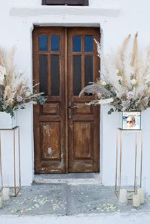 Μποέμ στολισμός εισόδου εκκλησίας με pampas grass, λευκό ανθούριο και τριαντάφυλλα