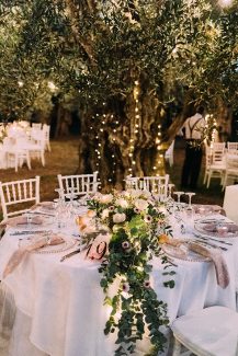 Ρομαντικός ανθοστολιμός με πρασινάδα για τραπέζι δεξίωσης