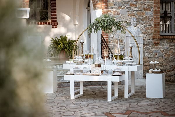 Candy table γάμου με επιτραπέζια αψίδα και φύλλα ευκαλύπτου