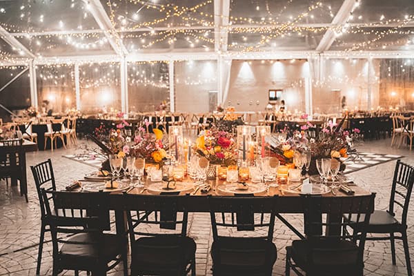 Fancy στολισμός γαμήλιου τραπεζιού με εντυπωσιακές ανθοσυνθέσεις σε ζωηρά χρώματα