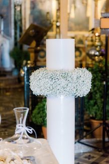 Λευκή λαμπάδα εκκλησίας που αγκαλιάζεται από γυψοφίλη